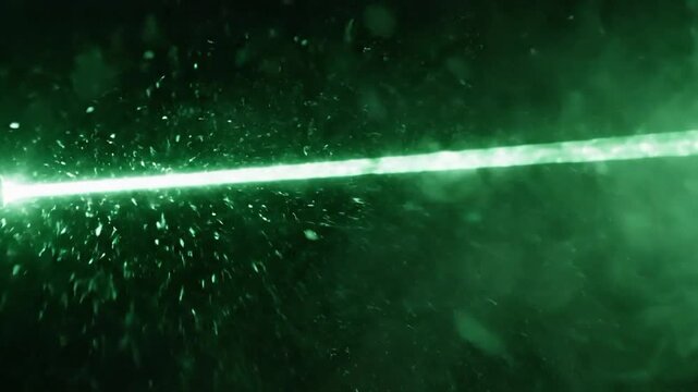 Laser beam cutting through smoke in a dark setting