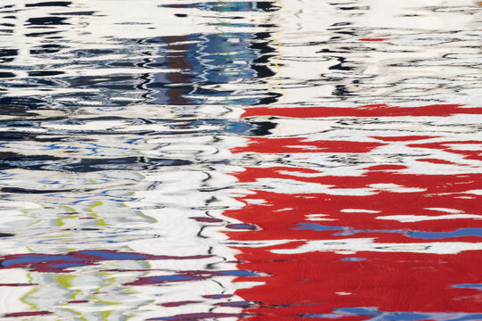 Colorful rippling Reflections on water surface in harbour