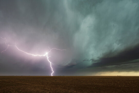 Lightning strike on plain under storm clouds in floydada, texas, USA
