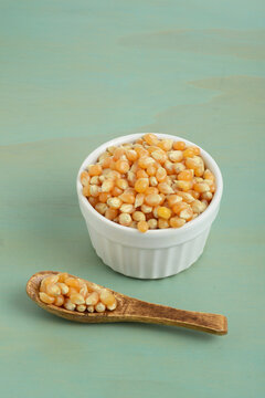 bowl of popcorn kernel seeds with a spoon