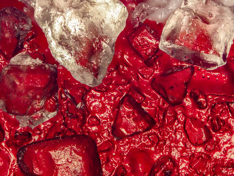 microscope view of red sugar-coated gummy candy under the microscope