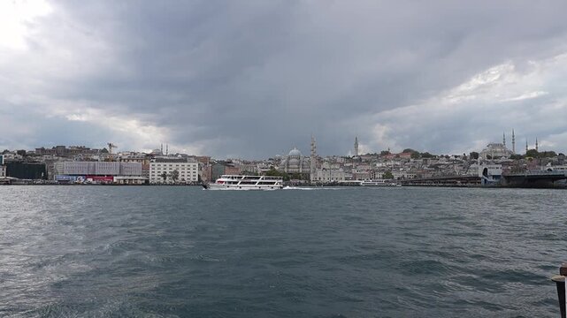 ISTANBUL, TURKEY - SEPTEMBER 23, 2026: Passenger ferry sailing on the Bosphorus Strait in Istanbul with scenic clouds, seagulls, and city skyline in the background.