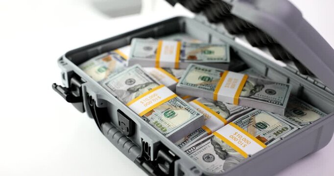 A person opens a professional briefcase to unveil neatly stacked bundles of cash. The setting is minimalistic and focused, highlighting the intrigue of hidden fortune.