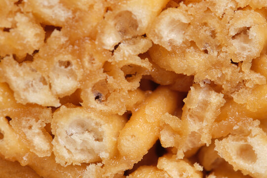 Macro close up texture crispy honey dough pieces inside traditional chak chak pastry.