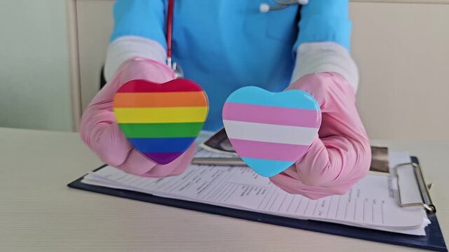 doctor holds an LGBT community flag in a hospital office. Medical support for the LGBT community and a symbol of tolerance.