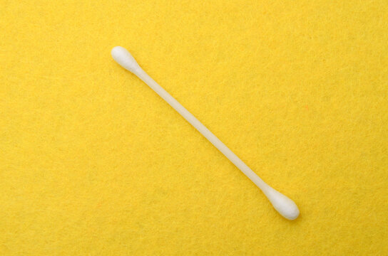 Cotton Swab on Yellow Felt Background for Personal Care Concept