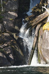 Water cascading over dark rock formations © CaptureQueen