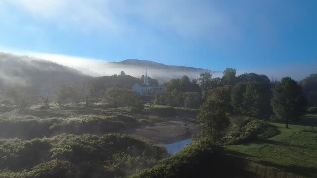Mistry foggy morning in rural northeast america. a cute church in every town. Stowe, vermont.