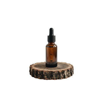 Facial serum dropper bottle on a rustic wooden pedestal PNG. Dark amber glass container for essential oils and anti-aging treatments. Mockup for holistic skincare and natural cosmetic brands PNG
