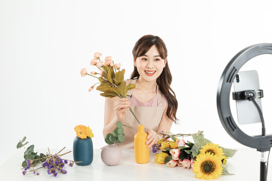 Female Florist Hosting a Live Streaming Flower Arrangement Workshop