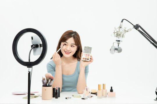 Beauty Influencer Applying Makeup During Live Stream Broadcast