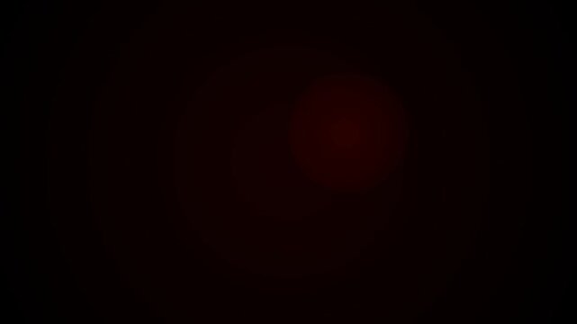 Red light softly glows in darkness