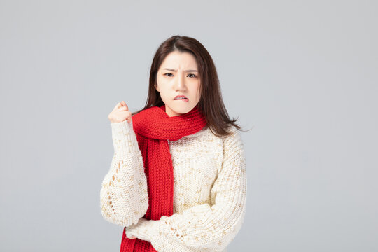 Young Asian Woman Shivering and Feeling Cold in Winter Clothing