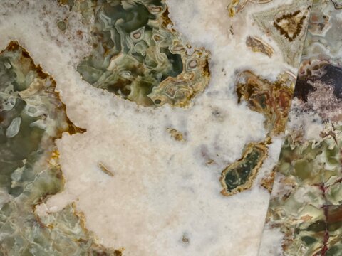 Polished green onyx marble texture, featuring natural white and cream crystalline veining.