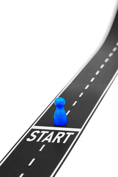 New beginning with a blue pawn at the start of a road