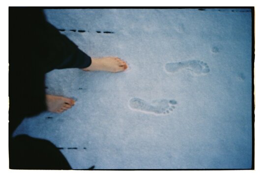 Feet touching fresh snow on a winter day