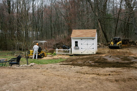 Tree stump grinding in a residential yard in massachusetts spring time