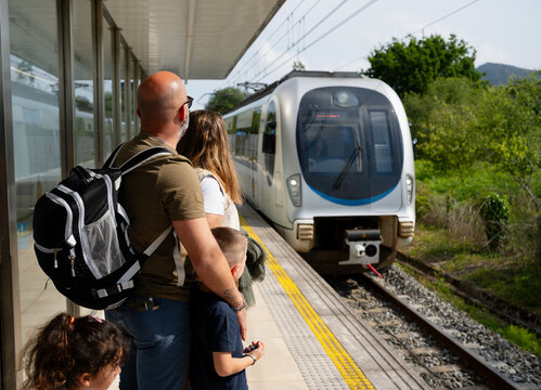 Family traveling by train waiting at station platform