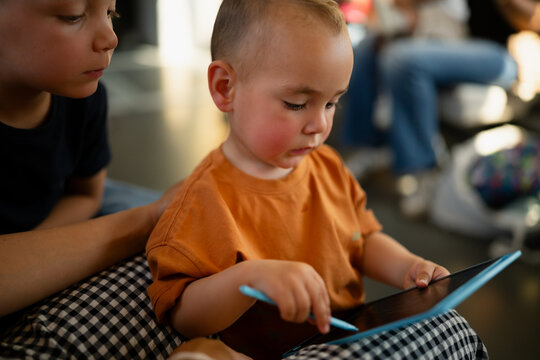 Toddler with tablet and stylus