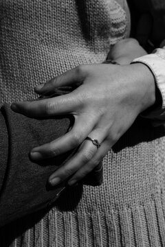 Close up of hands embracing waist