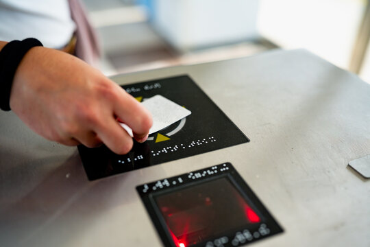 Hand scanning transit ticket at an access gate