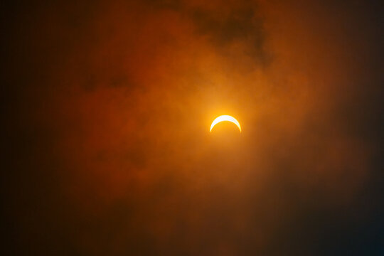 Solar Eclipse Through Clouds