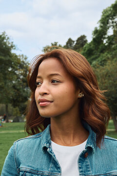 Young woman looking away outdoors in park