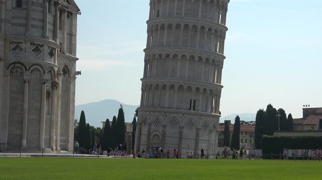 Leaning Tower of Pisa rises in Italy, white marble arches and columns forming an iconic landmark.