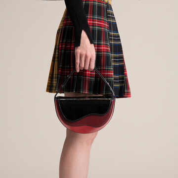 Hand Holding Handbag With Plaid Skirt
