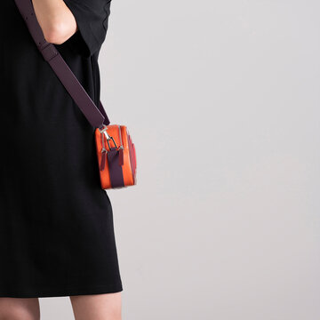 Black Dress With Orange Crossbody Bag