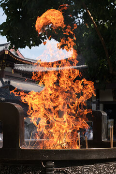Closeup of burning incense in a large burner at an Eastern temple