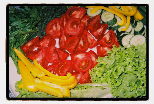 Garden vegetables cut and laid out for a shared meal