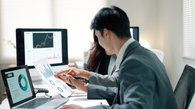 Business Team Discussing Financial Data in Office