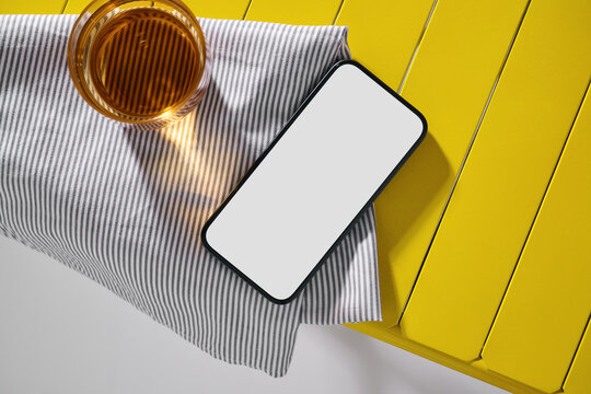 Smartphone and Drink on Striped Cloth