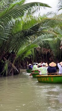 Hoi An, Da Nang, Vietnam - River Journey Through the Jungle on a Round Coconut Basket Boat, Brown River Waters, Traditional Vietnamese Hats, Overcast Rainy Weather, Authentic Round Boats, Exploring 