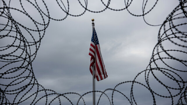 American flag on wire coil pole against dark sky