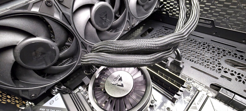 AIO liquid cooler tubes and radiator fans inside a custom desktop PC case
