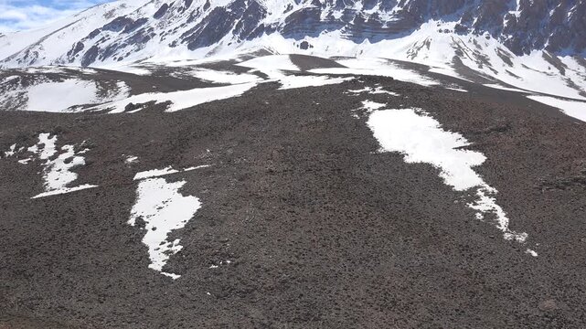 Wild horses roam treeless slopes below Kizlarsivrisi Mountain in Antalya, with patchy late snow.