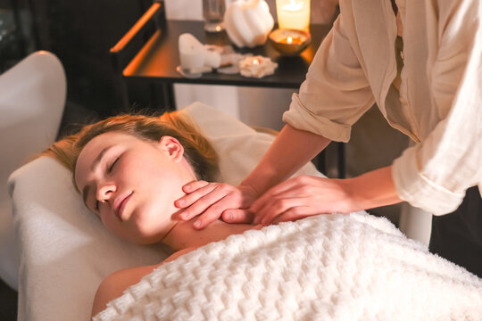 Woman receiving a gentle head massage at spa, illustrating neurowellness, nervous system regulation, stress relief, therapeutic touch, relaxation and holistic wellbeing.