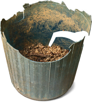 dirty broken plastic plant pot isolated white background, old green container with soil and cracked edges in close-up view