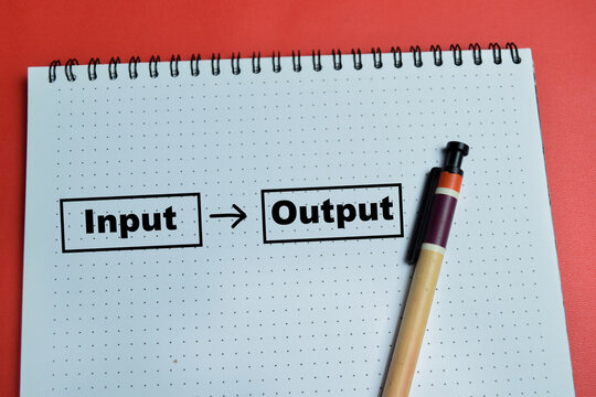 Concept of input to output write on book isolated on table. For process control, workflow and business data flow