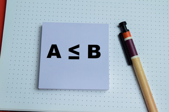 Concept of A is less than or equal B comparison write on sticky notes isolated on table. For mathematics and education