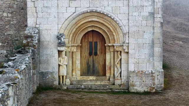 Peque&ntilde;a iglesia rom&aacute;nica de piedra construida sobre una colina rocosa con forma de barco al amanecer, con niebla en el Valle de Losa, Arquitectura medieval antigua, templo hist&oacute;rico rural, Pantale&oacute;n.