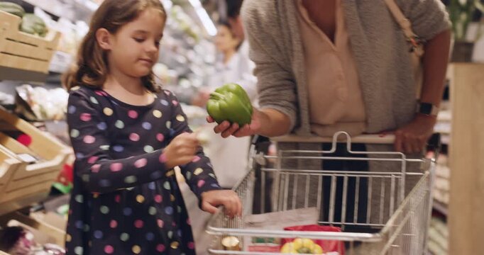 Mom, child or vegetable at supermarket for shopping, healthy choice or grocery sale on green pepper. Happy mother, kid or cart at store with fruit selection, retail bargain or explain nutrition value