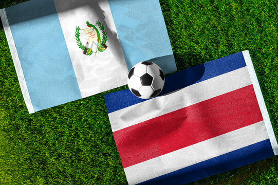 Guatemala vs. Costa Rica football match. National flags on green grass with soccer ball in the middle. Football background for international match.