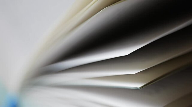 book pages in slow motion revealing text for reading, studying, and learning, close up shot of a paper textbook