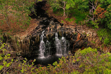 Family on the background of the Rochester waterfall on the island of Mauritius from a height.Waterfall in the jungle of the tropical island of Mauritius © Alex