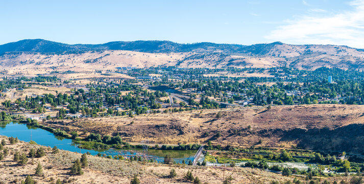 Aerial perspective of Klamath Falls, Oregon, showcasing the Link River winding through the valley with surrounding hills and the city.