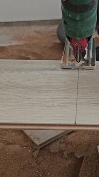 Cutting tiles with a power tool for flooring installation process