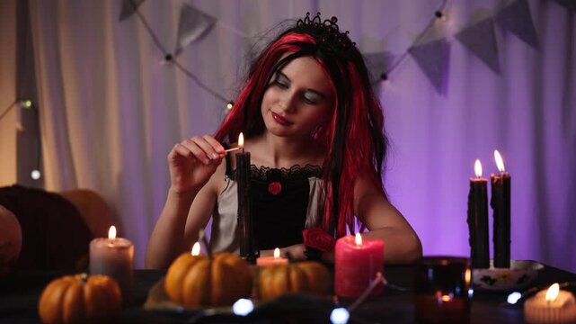 Cute Little Girl In A Halloween Witch Wig Plays With Candles And Casts Magic Spells